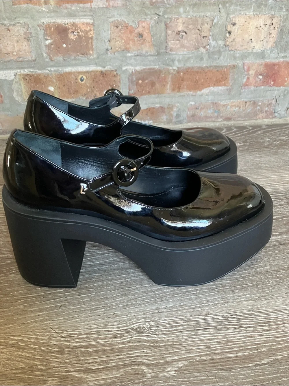 Larroude Olivia Platform Pumps in glossy black patent leather.
